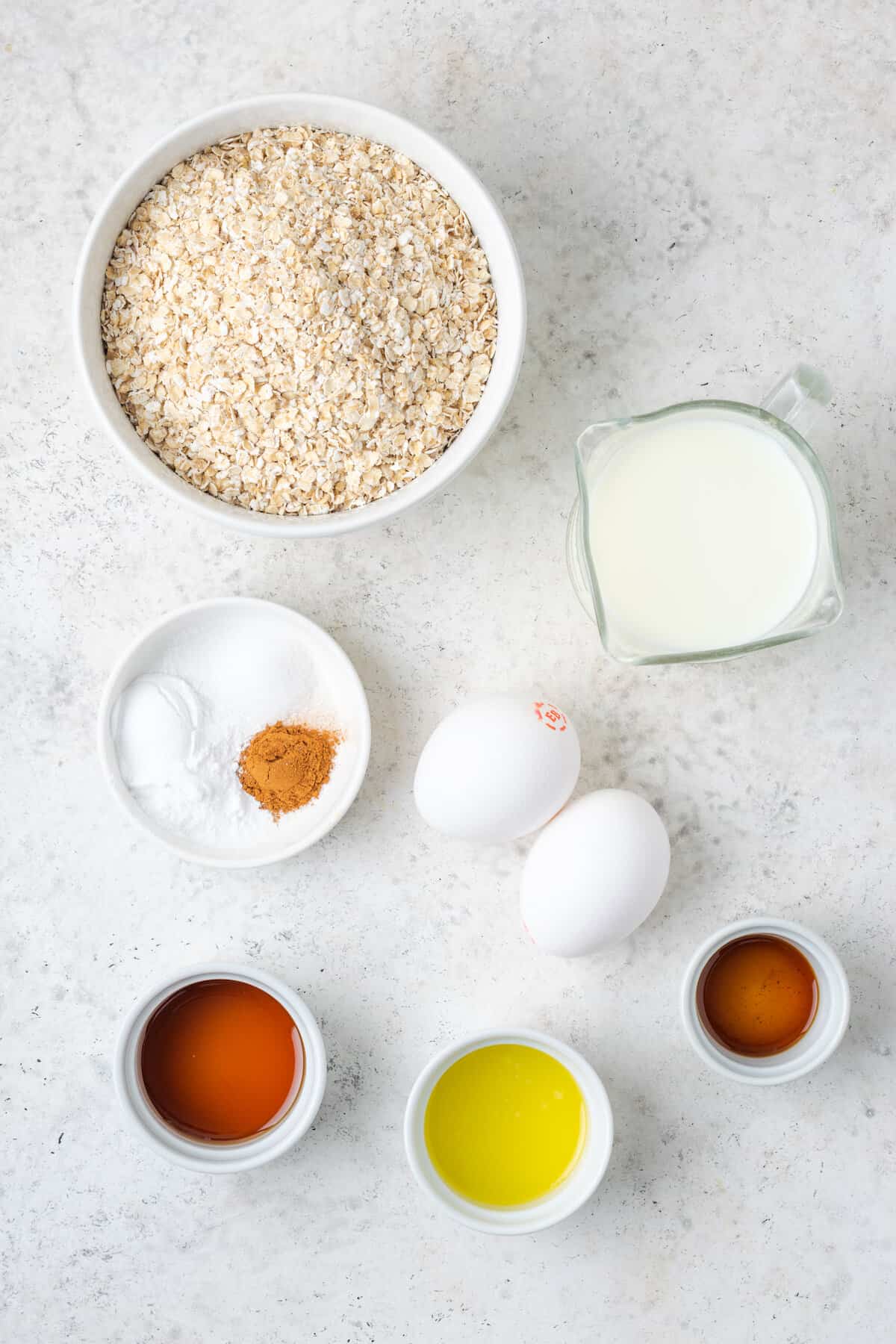 Ingredients for oatmeal pancakes - oats, milk, butter, vanilla, eggs.