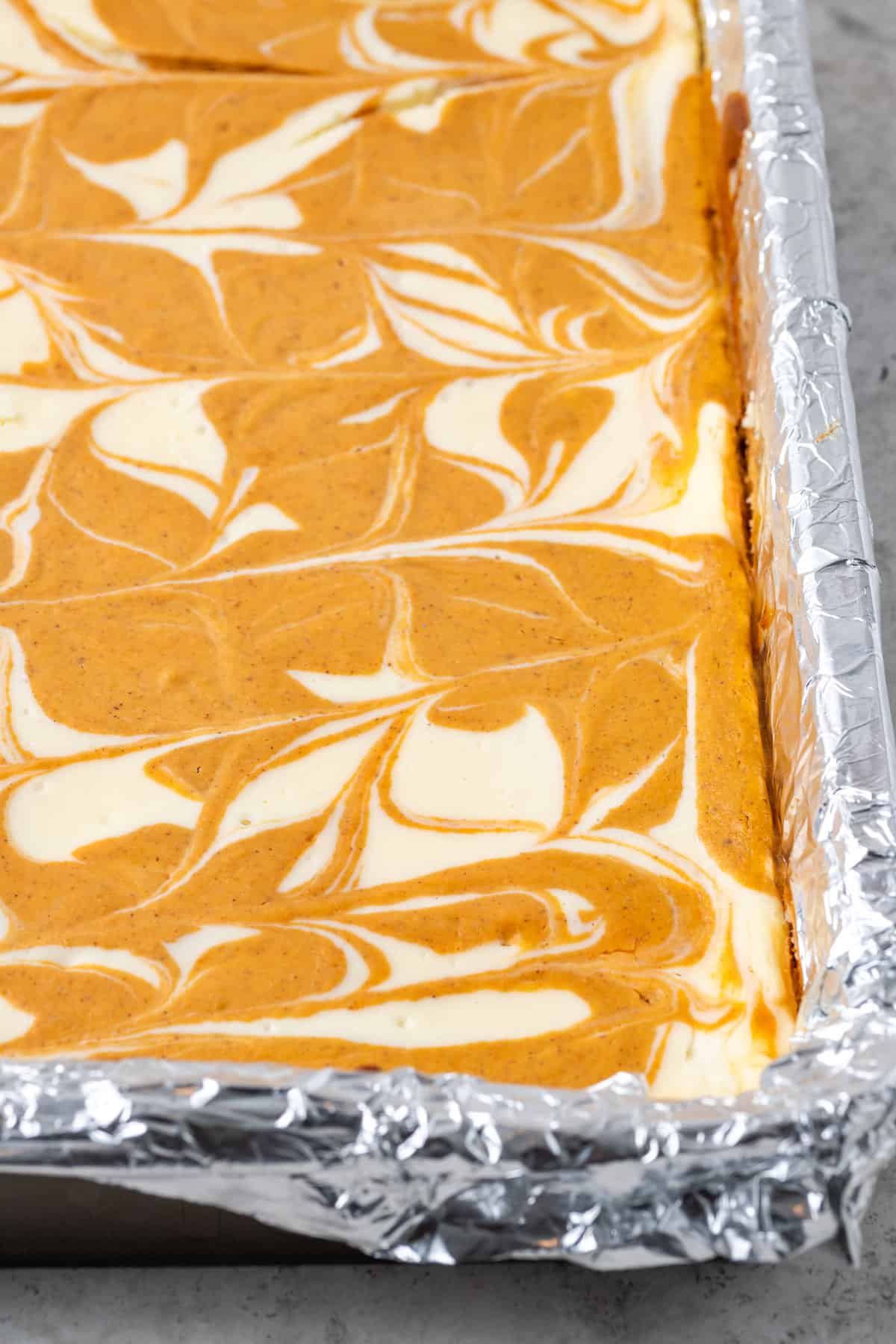 Close up of swirled pumpkin and cheesecake filling.