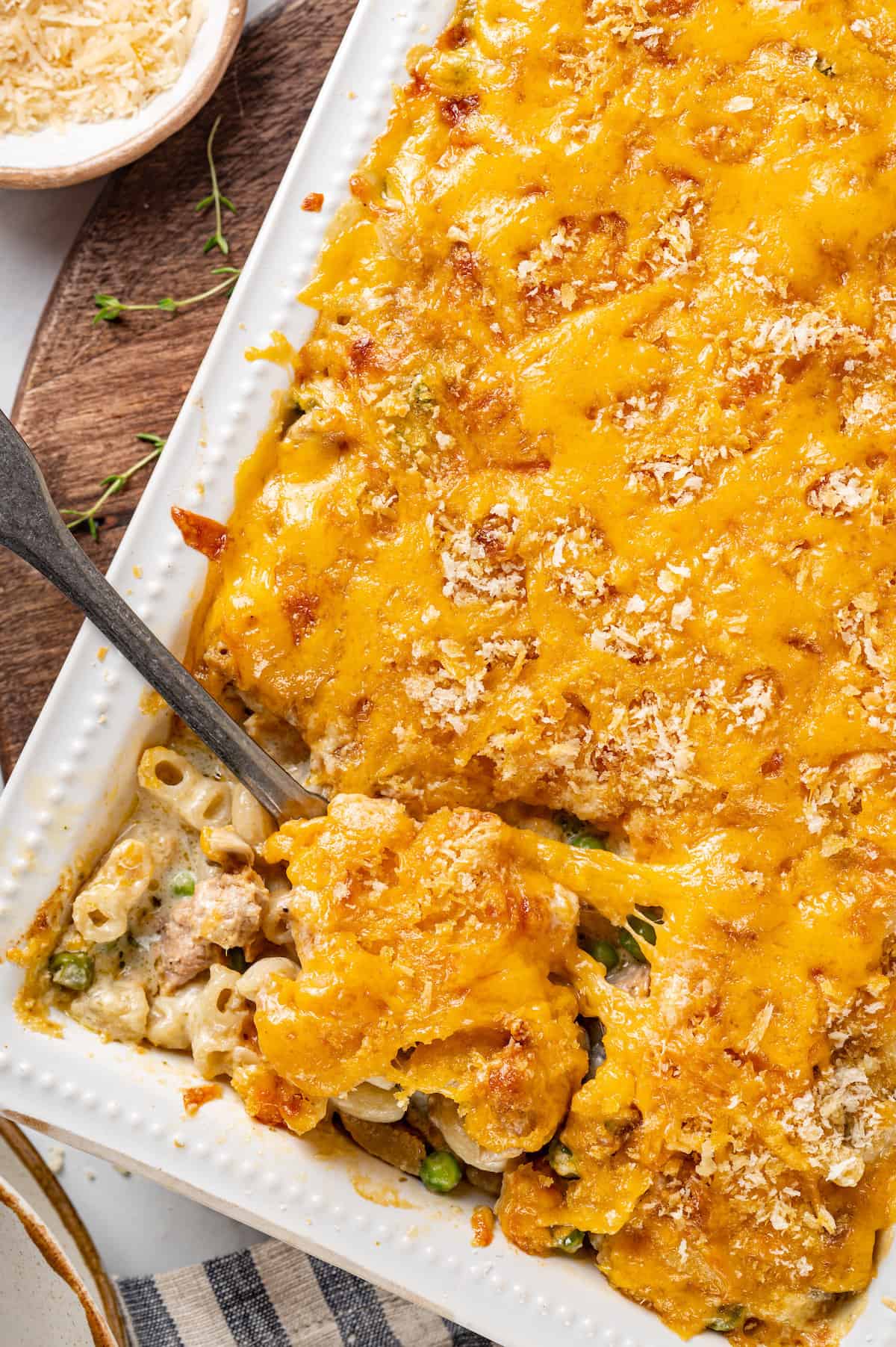 A spoon lifts out a portion of gluten-free tuna noodle casserole.