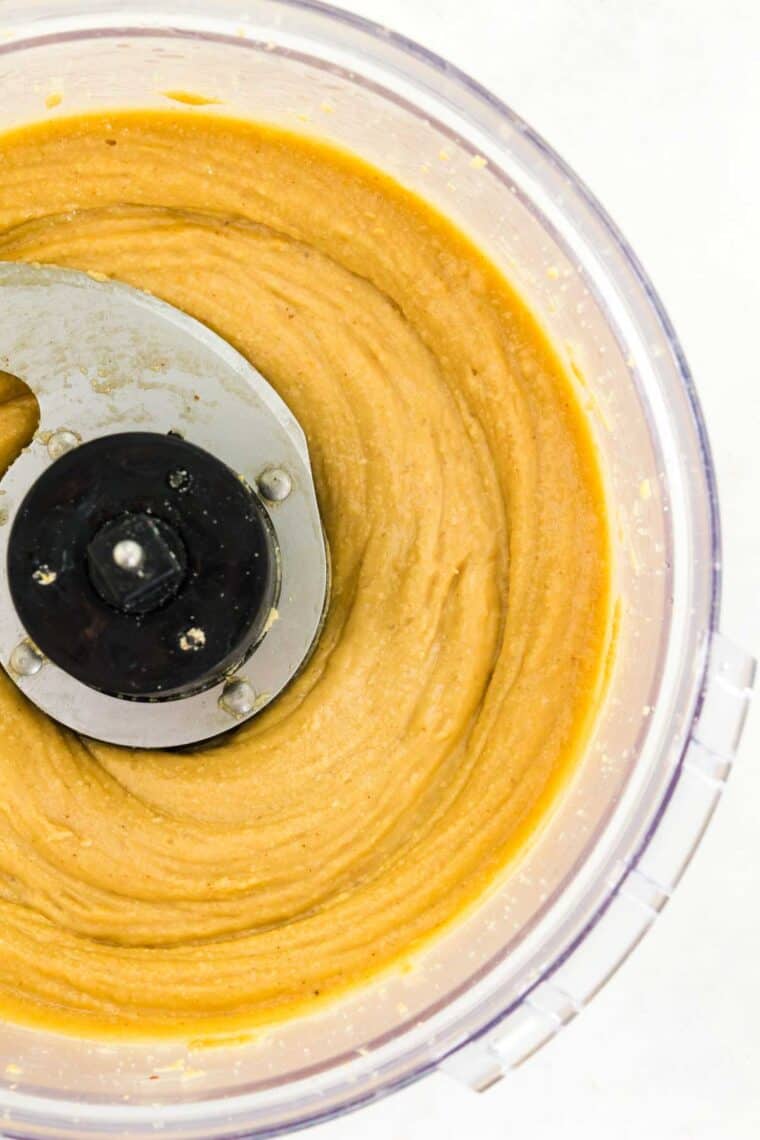 Homemade peanut butter is shown in a food processor.