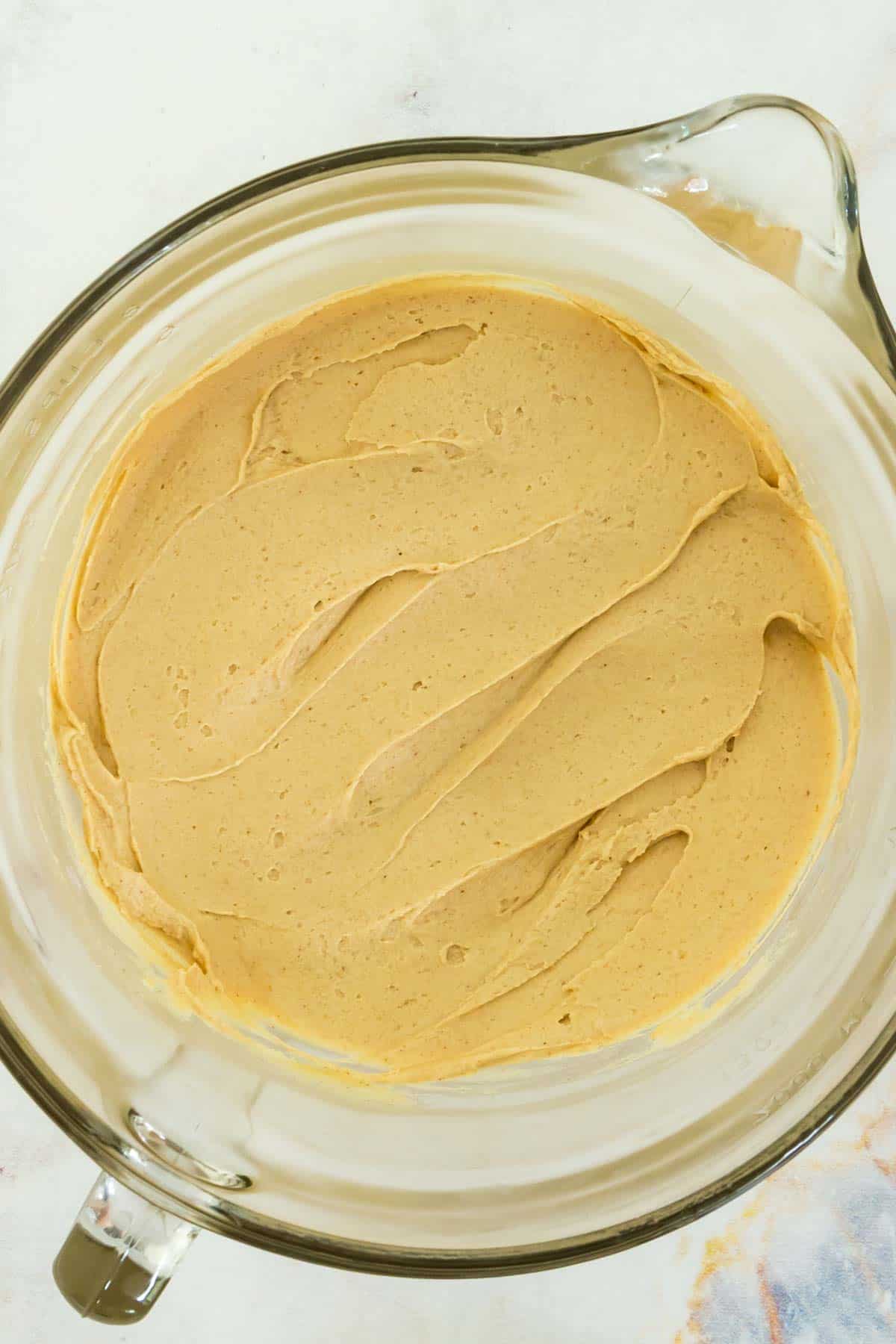 Peanut butter frosting is shown in a bowl.