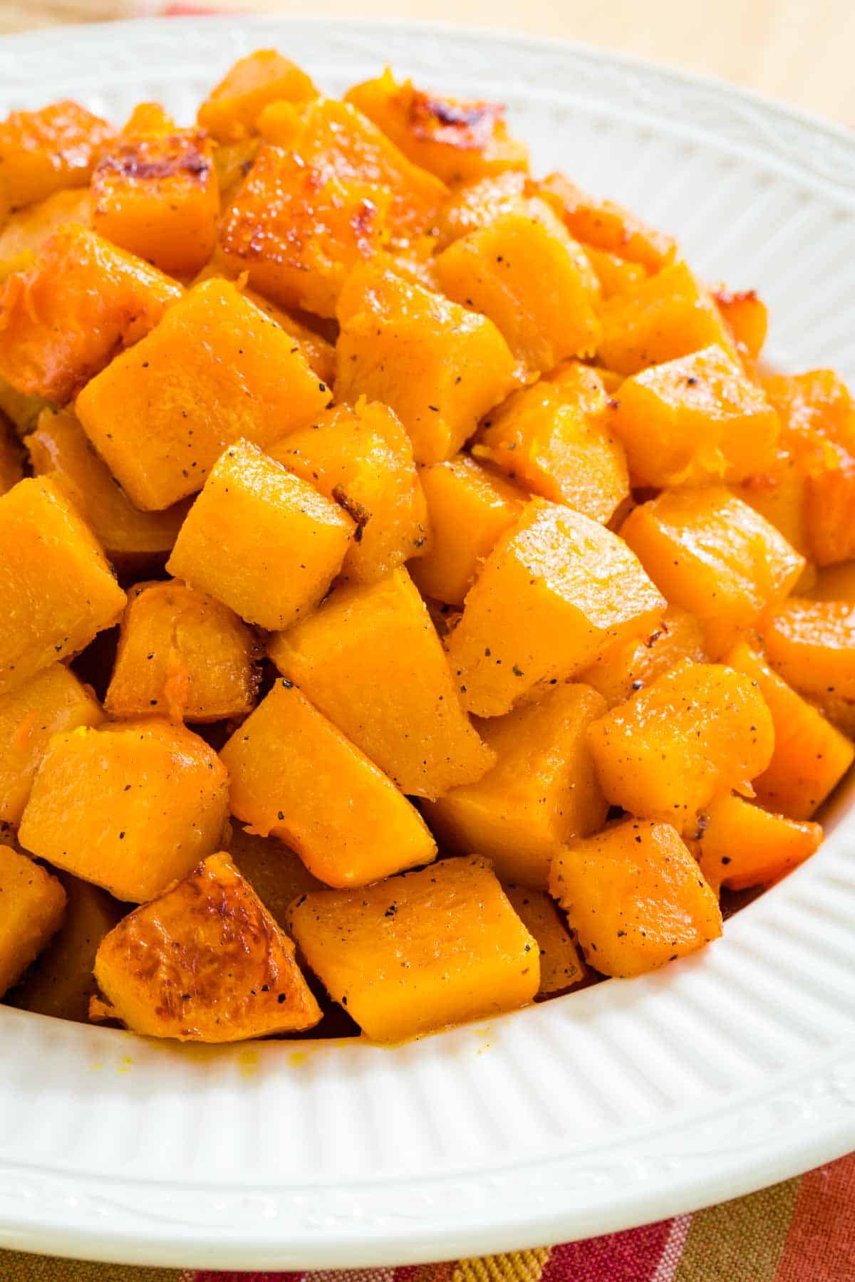 A white bowl of roasted butternut squash.