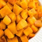 A white bowl of roasted butternut squash.