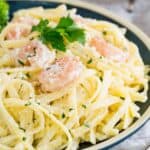 A plateful of shrimp alfredo with text overlay that says "Gluten Free Shrimp Alfredo".