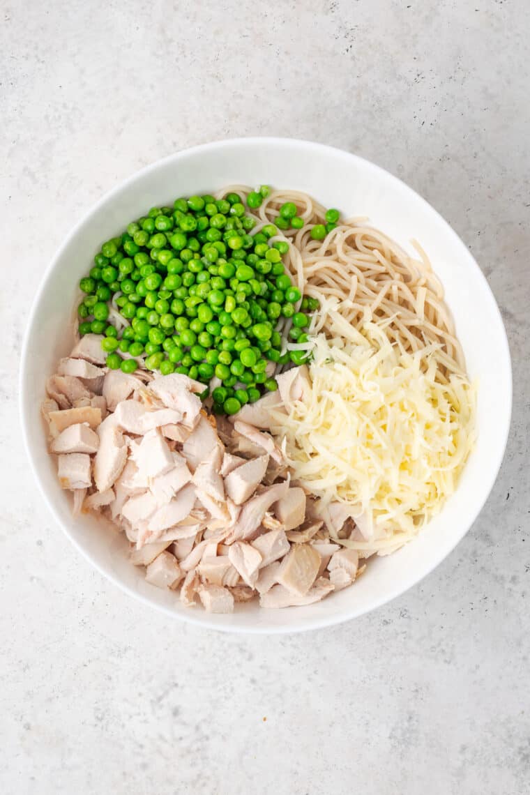 A bowl of chicken tetrazzini ingredients.