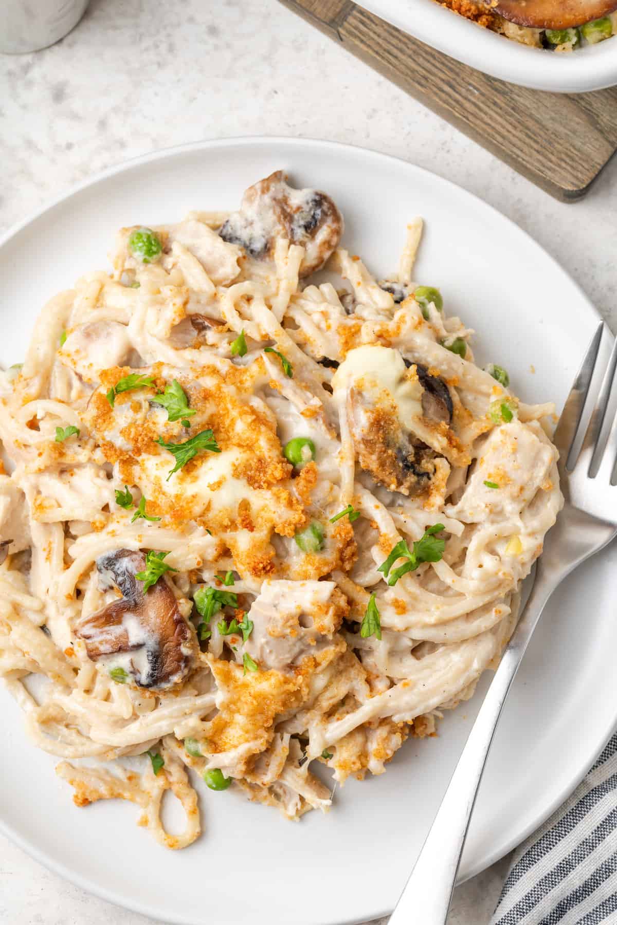 A plate of chicken tetrazzini with a fork.
