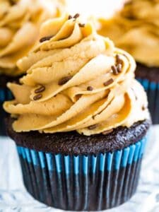 A gluten free chocolate cupcake is shown topped with peanut butter frosting.