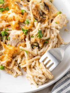 A plate of chicken tetrazzini with a fork.
