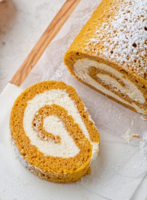 A gluten free pumpkin roll and a slice of pumpkin roll.