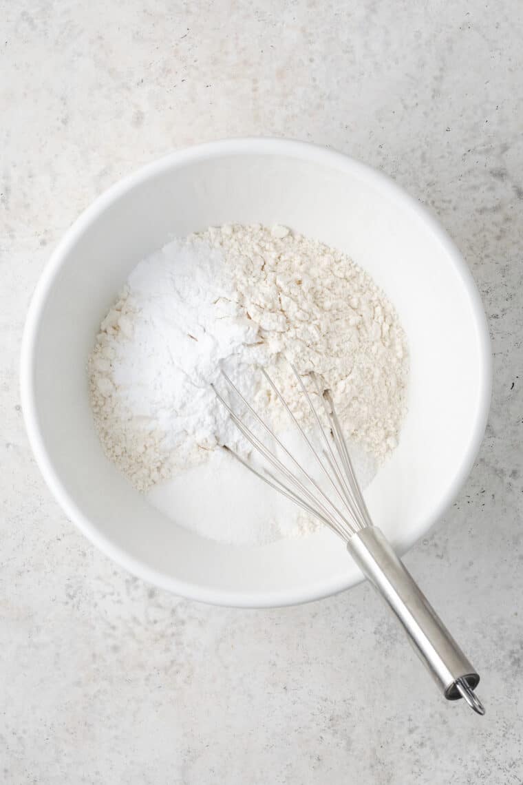Dry ingredients are whisked together in a bowl for sheet pan pancakes.