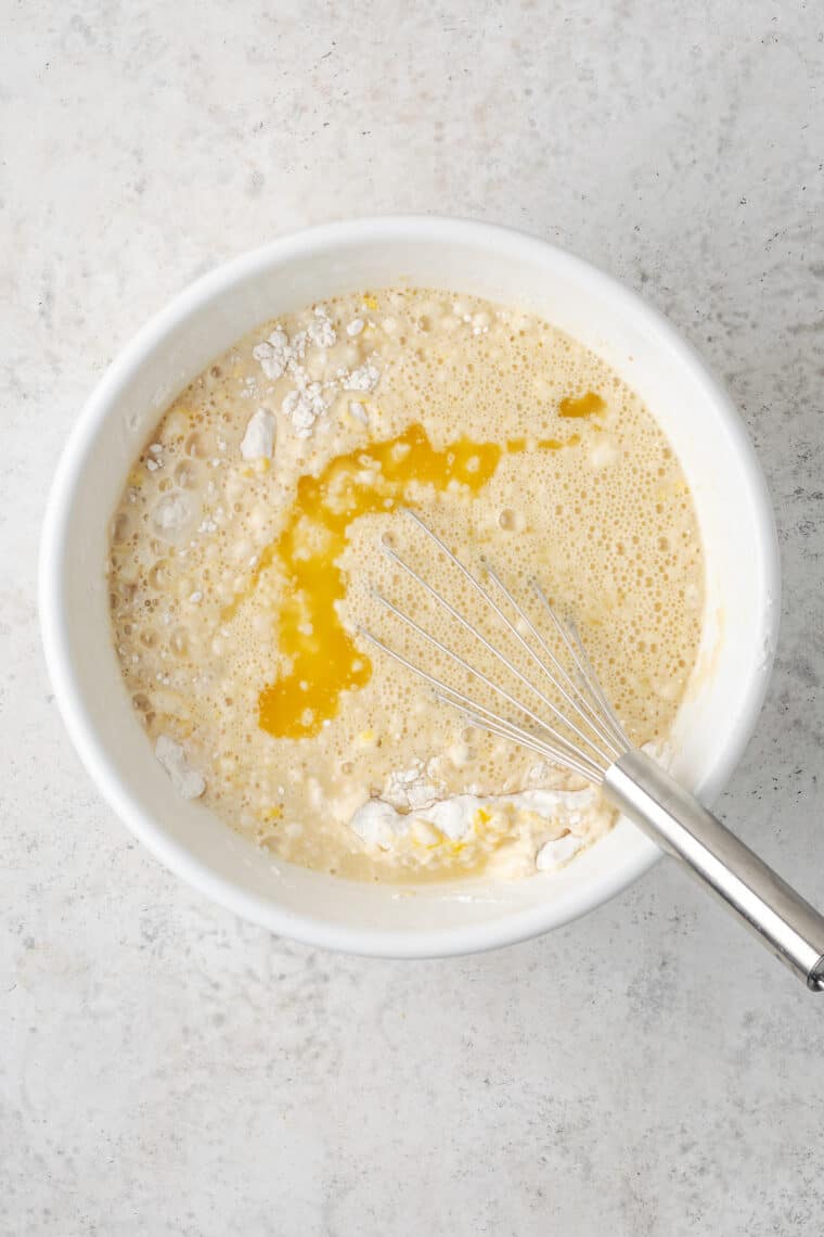 Wet and dry ingredients are combined in a bowl for pancakes.