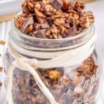 A glass jar filled with chocolate granola.