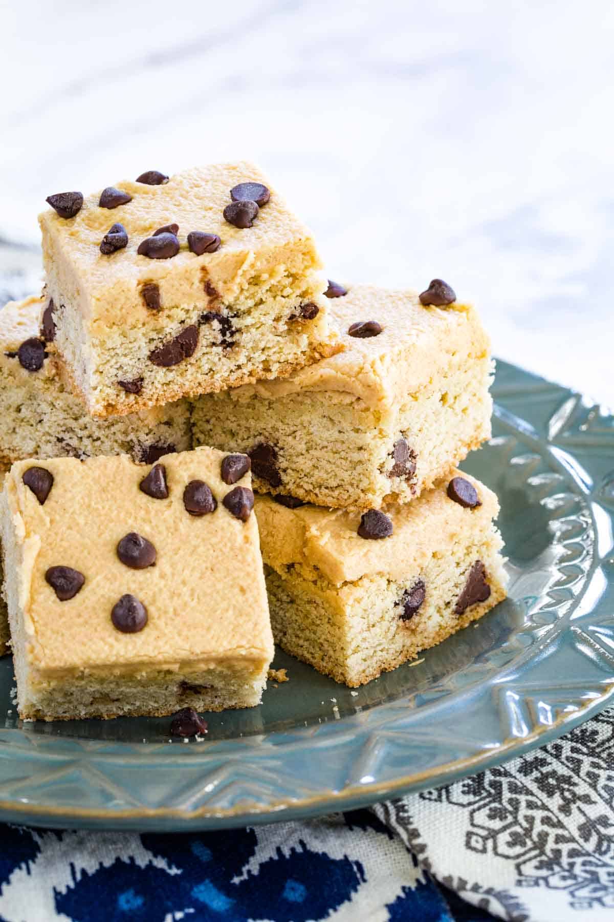 A blue plate of chocolate chip cookie bars.