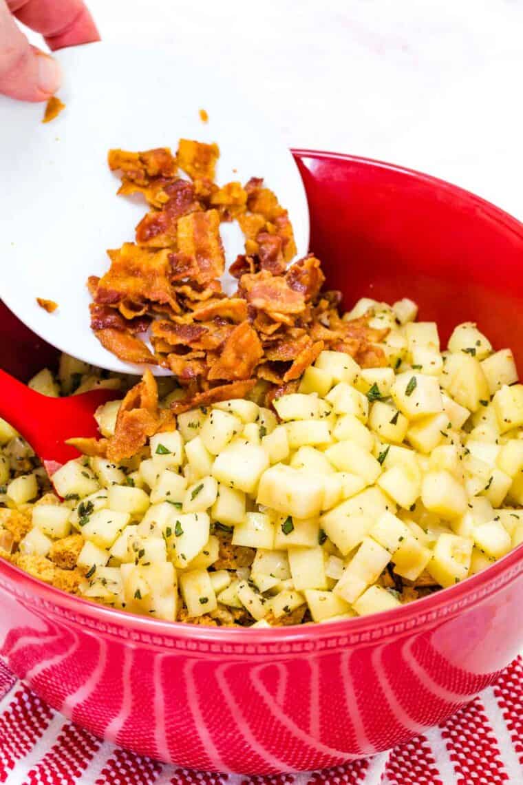 Bacon is added to a pan of gluten free apple stuffing.