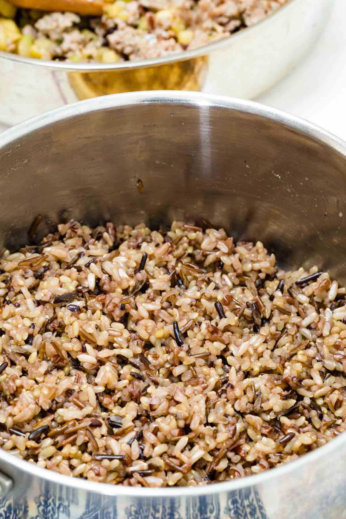 A saucepan full of cooked wild rice.