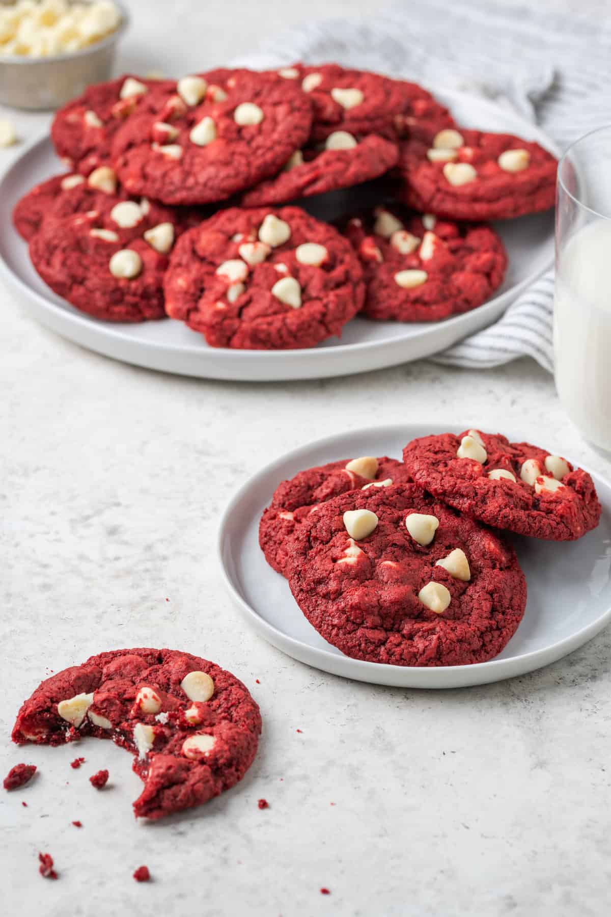 A plate and a platter holds gluten free red velvet cookies.