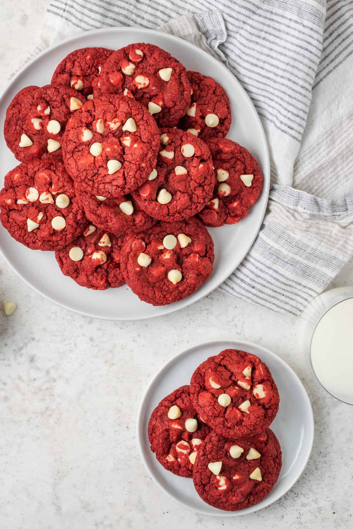 An overhead shot of plates of red velvet cookies.