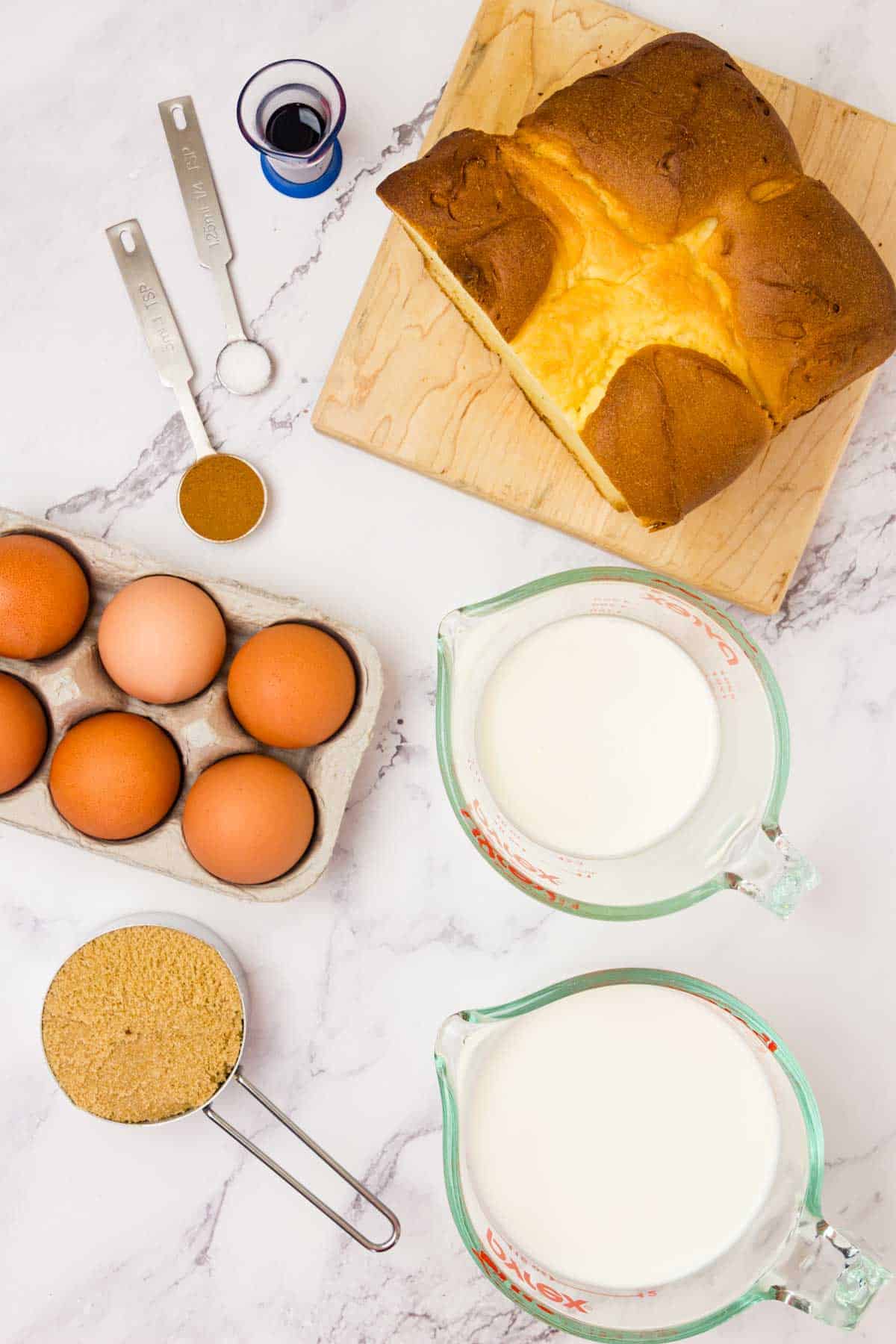 The ingredients for French toast casserole are shown: eggs, bread, milk, cream, brown sugar, cinnamon.
