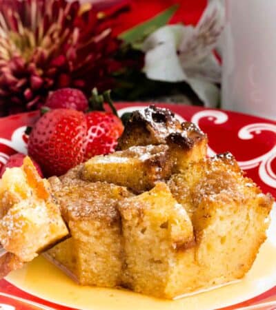 A piece of French toast casserole topped with fruit on a plate.