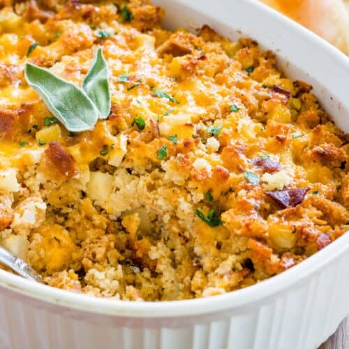 Stuffing with apples and cheddar cheese in a casserole dish.