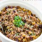 Wild rice stuffing in a casserole dish with text overlay that says "Wild Rice Stuffing".