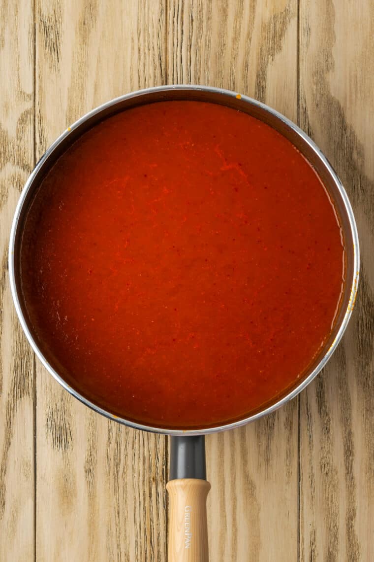 A metal pot of red sauce.