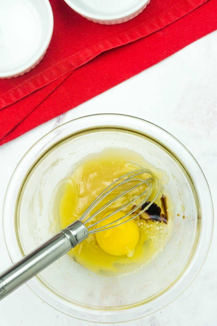 An egg is whisked into the sugar and butter mixture.