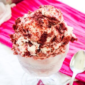 Red velvet ice cream in a glass sundae dish.