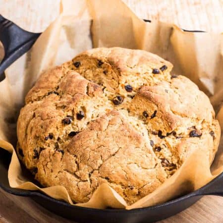 The baked Irish soda bread loaf rests in the pan.