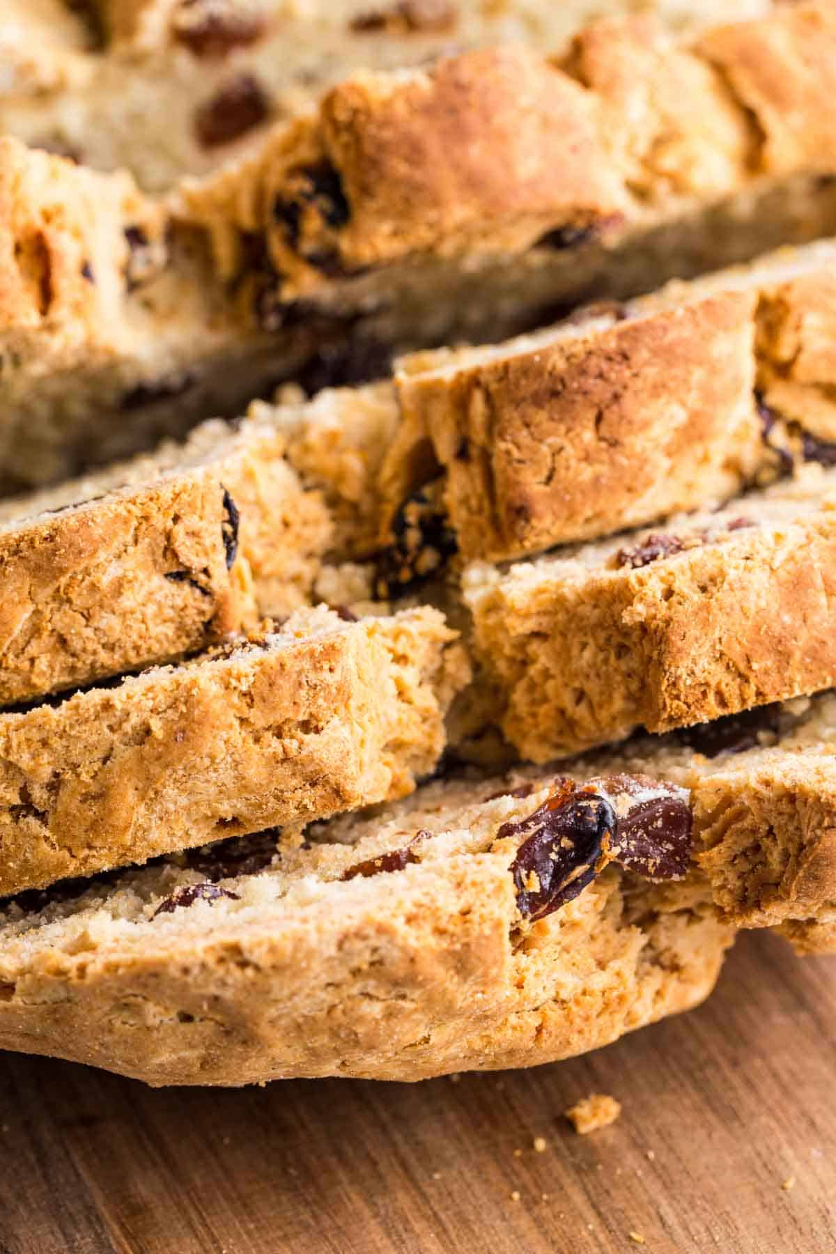 A close up shows crusty slices of Irish soda bread.