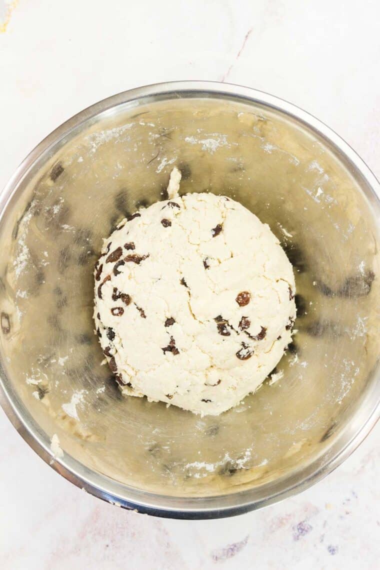 A ball of Irish soda bread dough in a metal bowl.