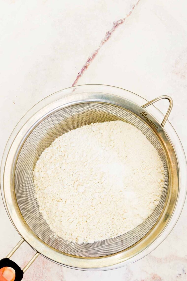 Sifting the dry ingredients together for gluten free white cake.