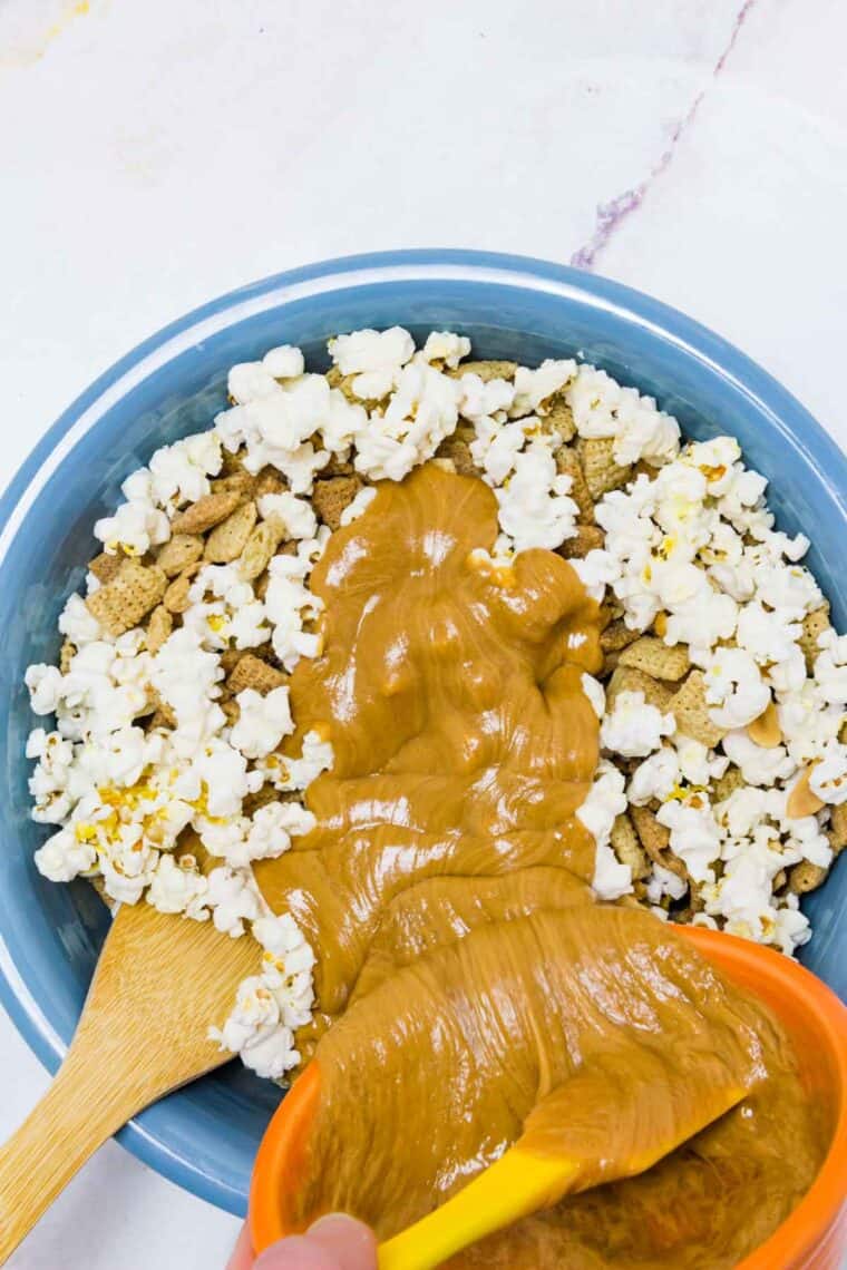 Peanut butter is added into the popcorn mix.