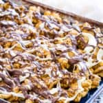 A tray of white chocolate popcorn on a striped towel.