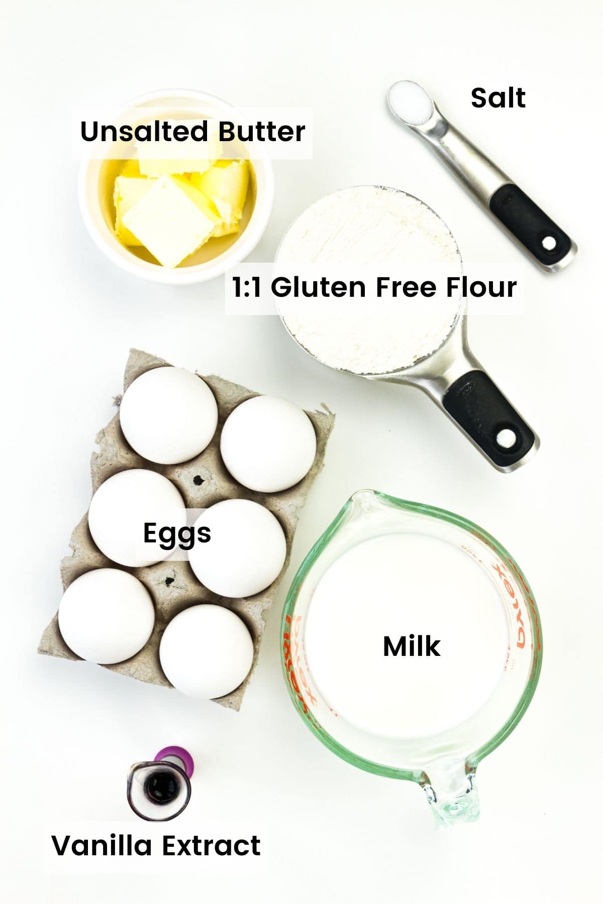 Ingredients for gluten free German pancakes are shown: gluten free flour, butter, eggs, milk, vanilla, salt.