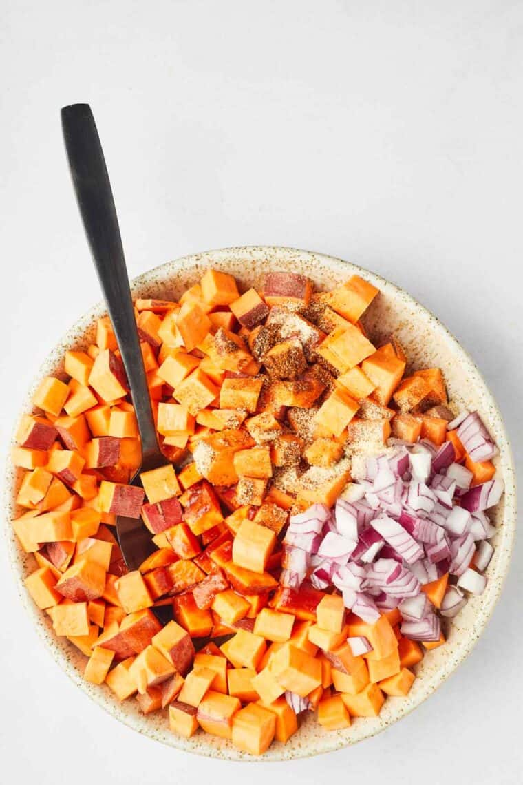 A spoon mixes the ingredients together in a bowl.