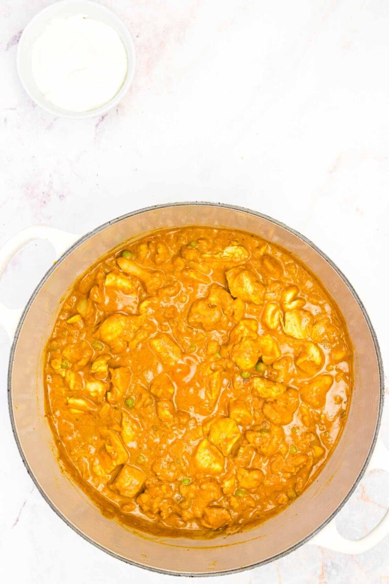 The curry is shown in the pot with all of the ingredients mixed together.