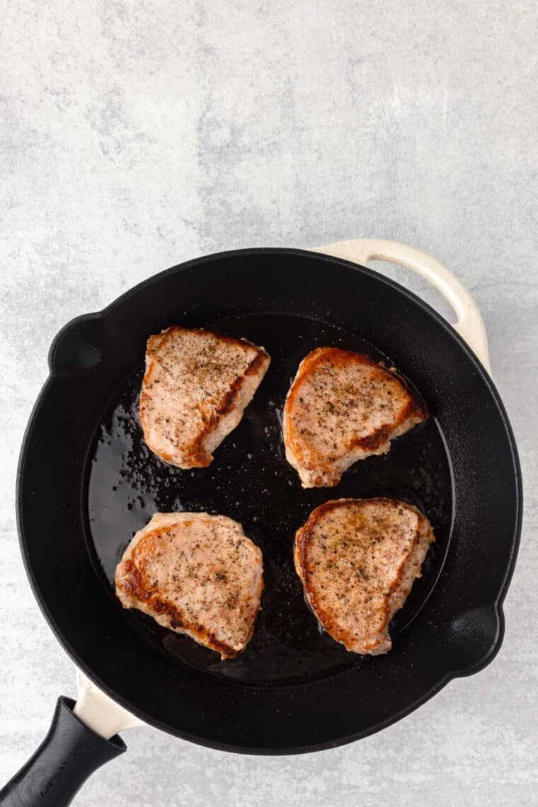 The chops are flipped to sear the other side.