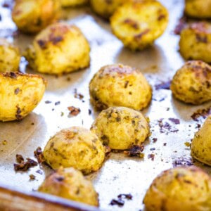 Pesto roasted potatoes on a baking pan.