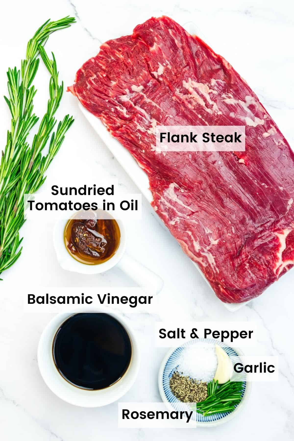 Ingredients for balsamic marinated steak are shown labelled: rosemary, balsamic vinegar, sundried tomatoes in oil, salt, pepper, garlic, and flank steak.