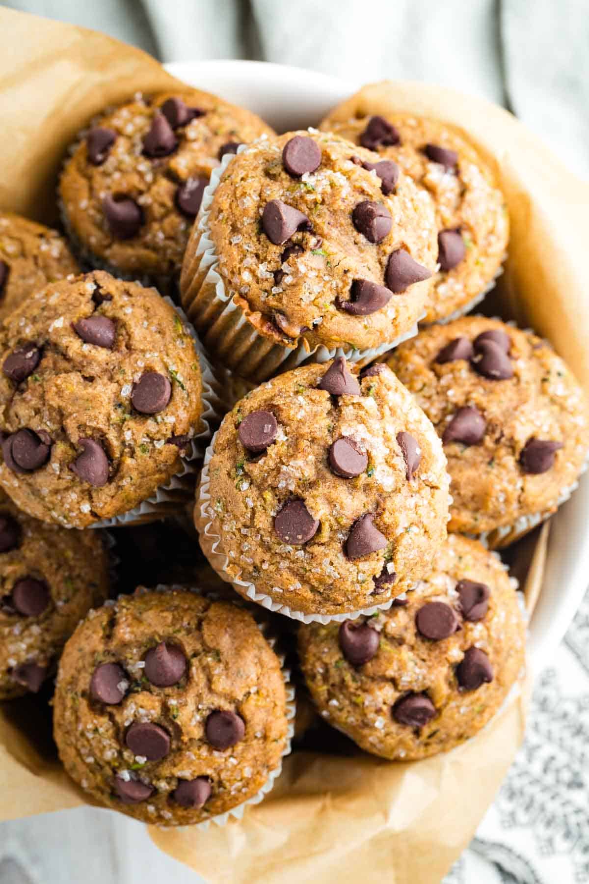 A big bowl of zucchini muffins with chocolate chips.