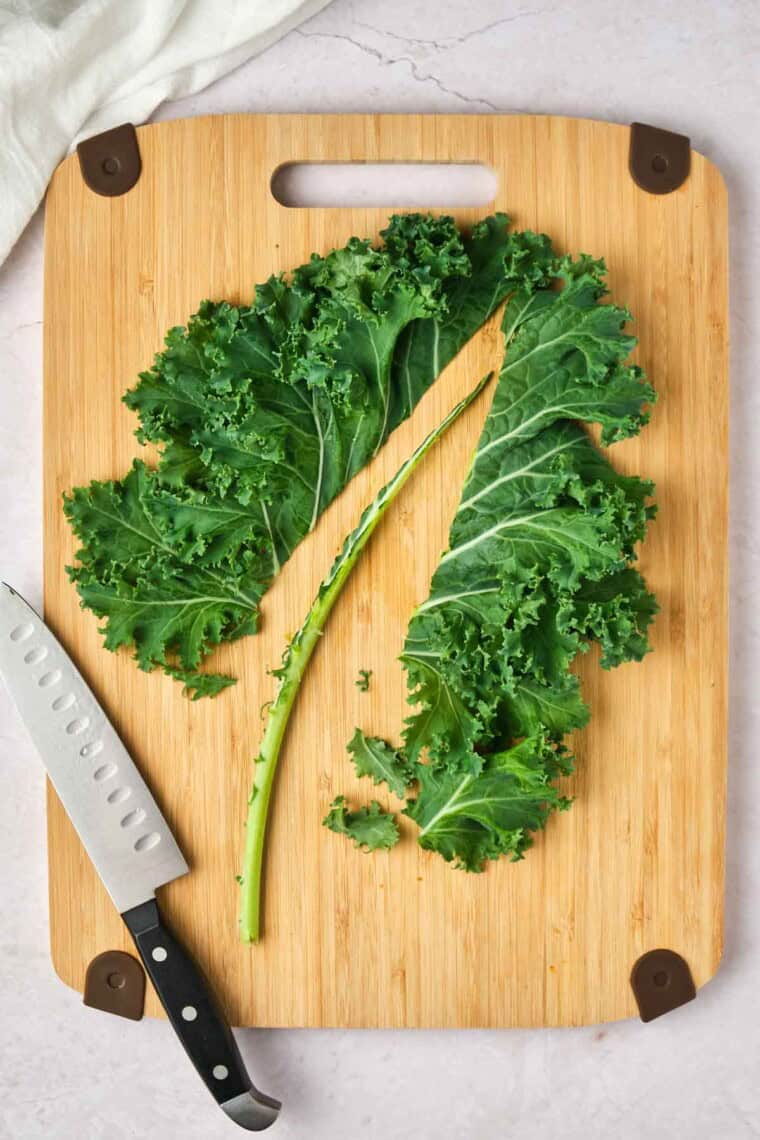 The rib is removed from a kale leaf.