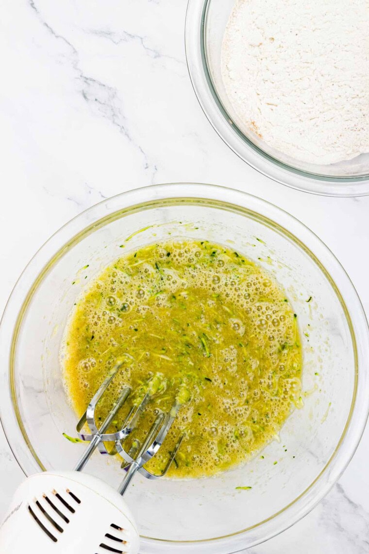 Shredded zucchini is beaten into the wet ingredients.