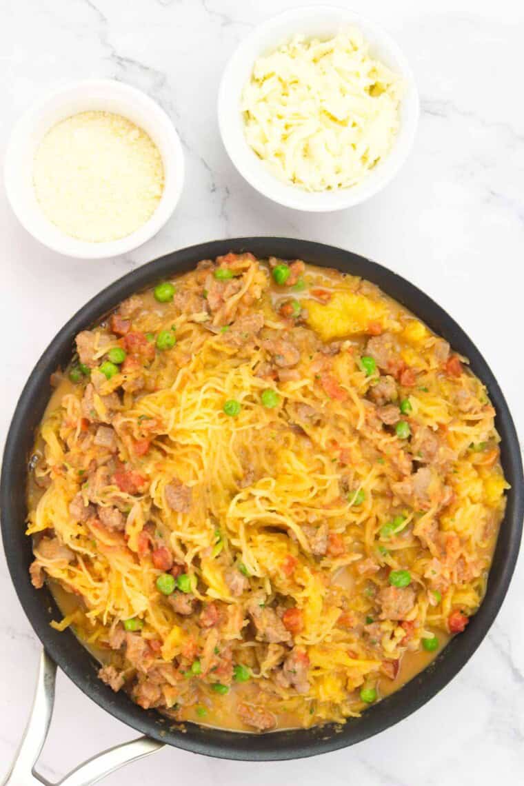 Spaghetti squash noodles combined with the sauce in the pan.