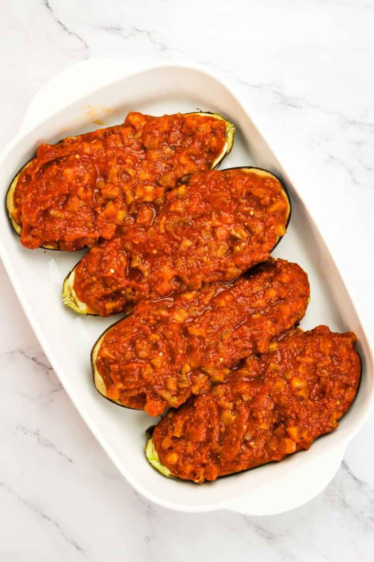 The homemade tomato sauce covers the four pieces of eggplant.