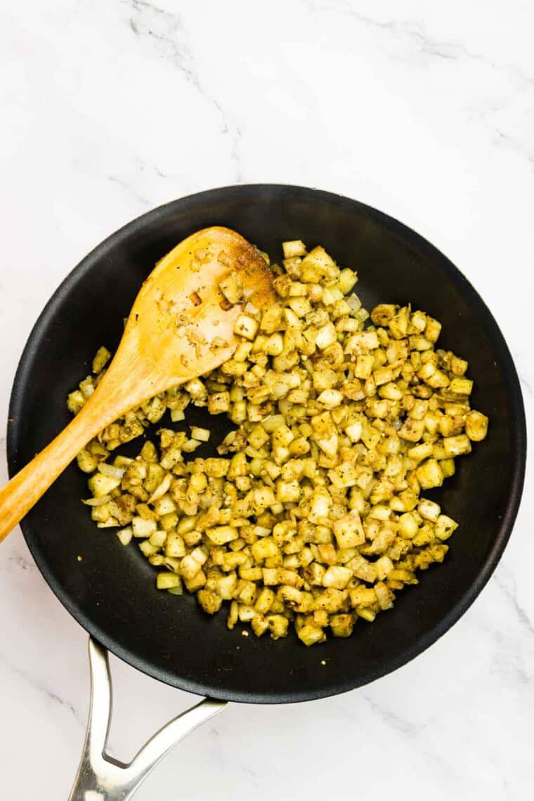 The eggplant browns in a skillet.