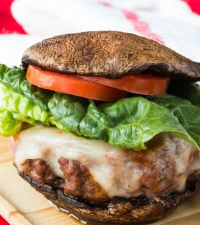 An Italian burger is served on grilled portobello mushroom caps.