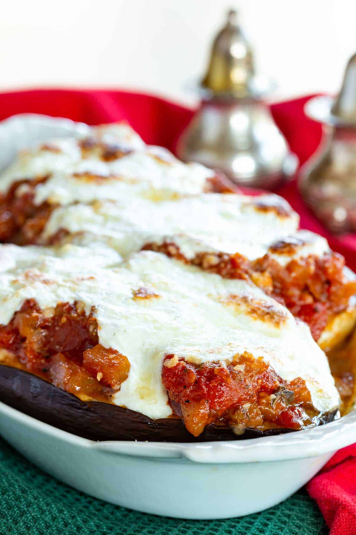 Stuffed eggplant parmesan is topped with tomato sauce and melted mozzarella.