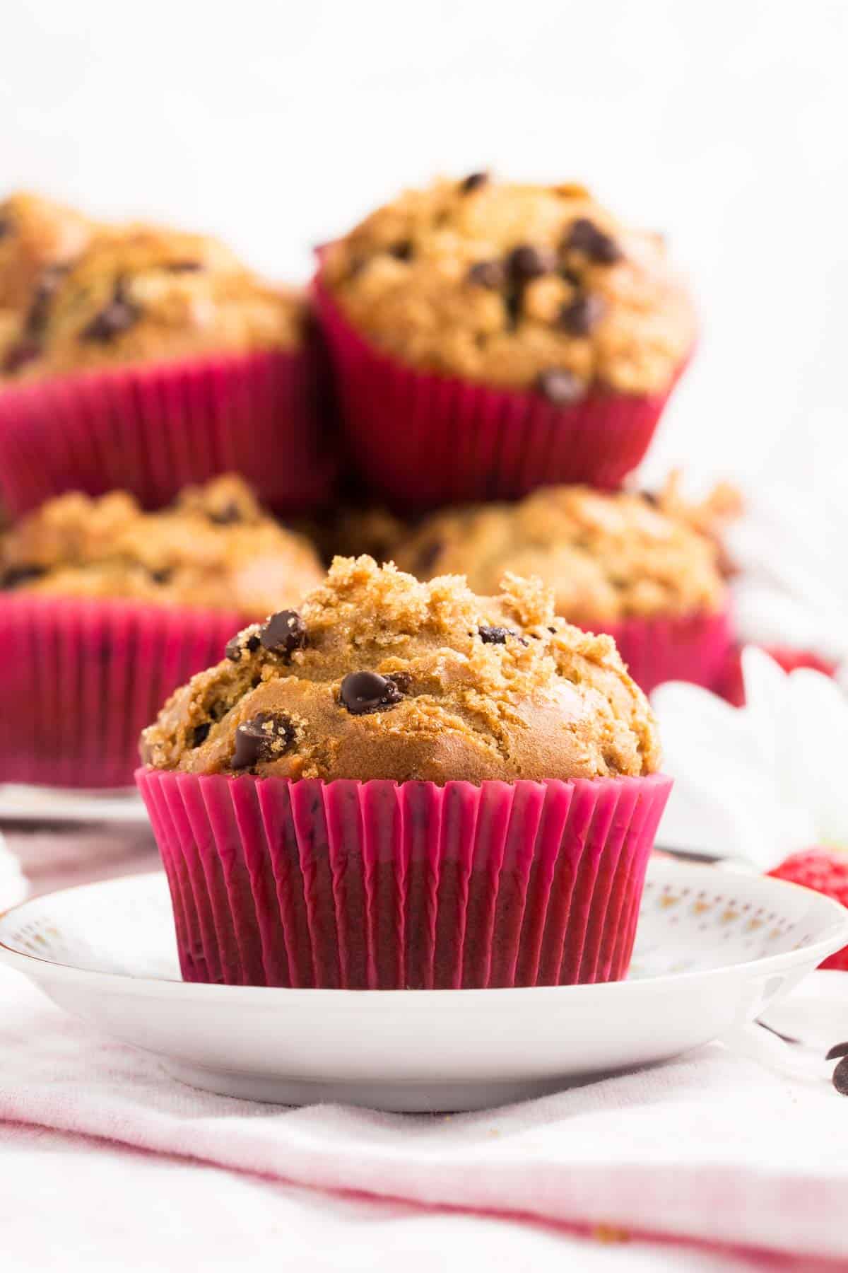 Red cupcake liners hold gluten free raspberry muffins.