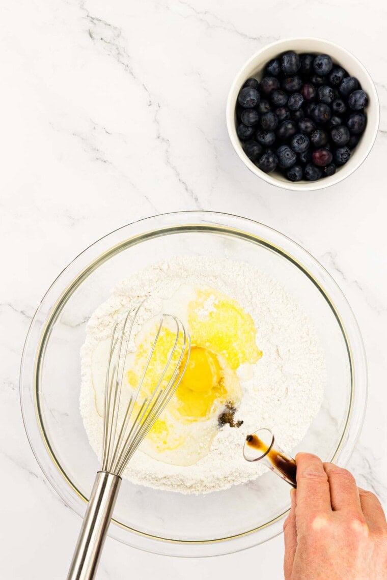 The wet ingredients are whisked together in a bowl.